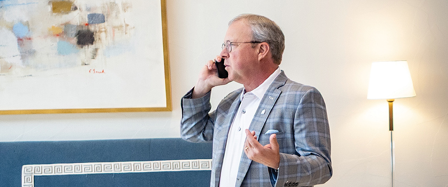 Man in suit speaking on phone