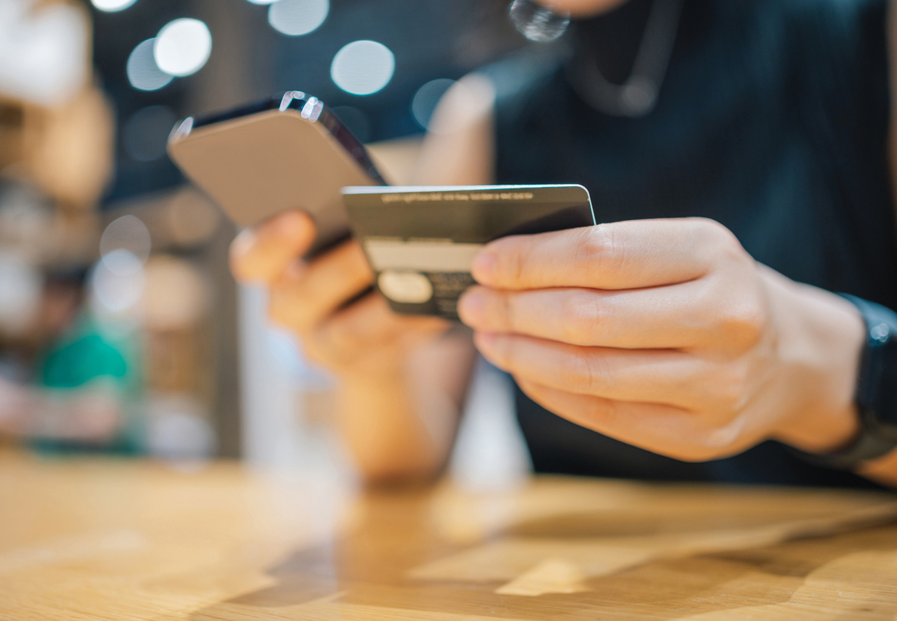 Credit card held next to phone