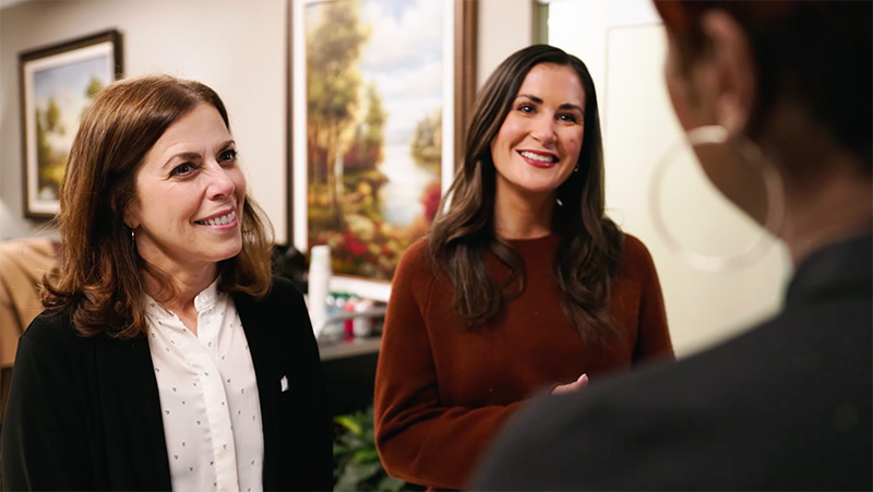 Bankers smiling in front of client