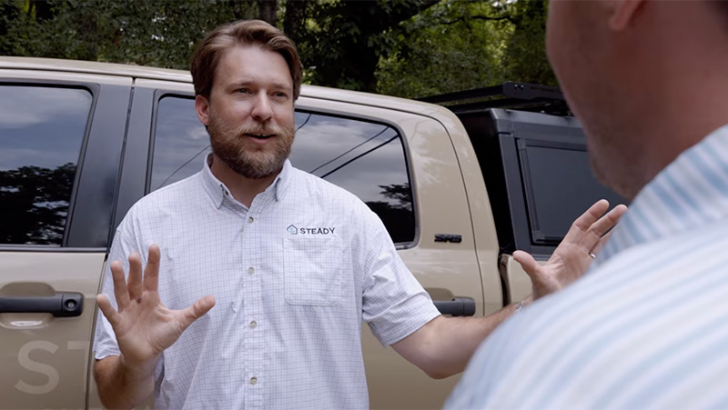 Steady Home Maintenance founder discusses home care services with a client outdoors